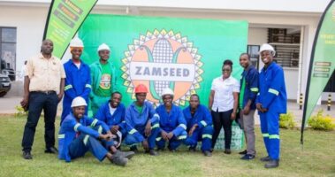 Zamseed staff with the donated cases of drinking water