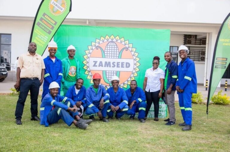 Zamseed staff with the donated cases of drinking water